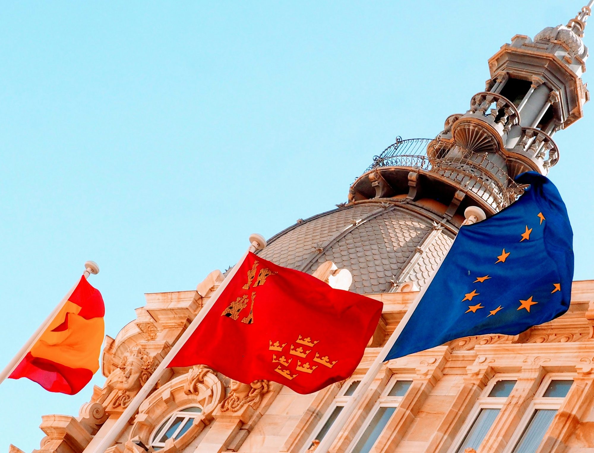 Spanish, regional and EU flags on a civic building