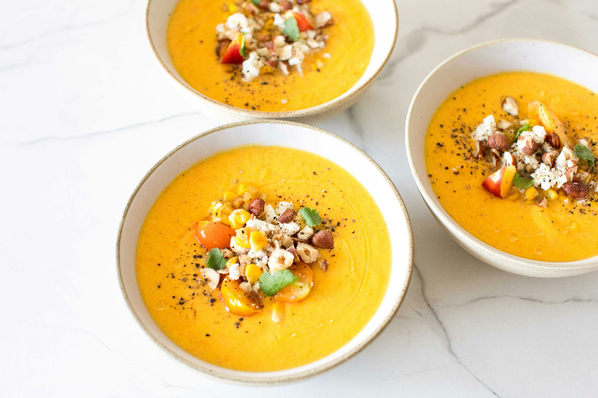 Three bowls of regional Spanish soup with toppings